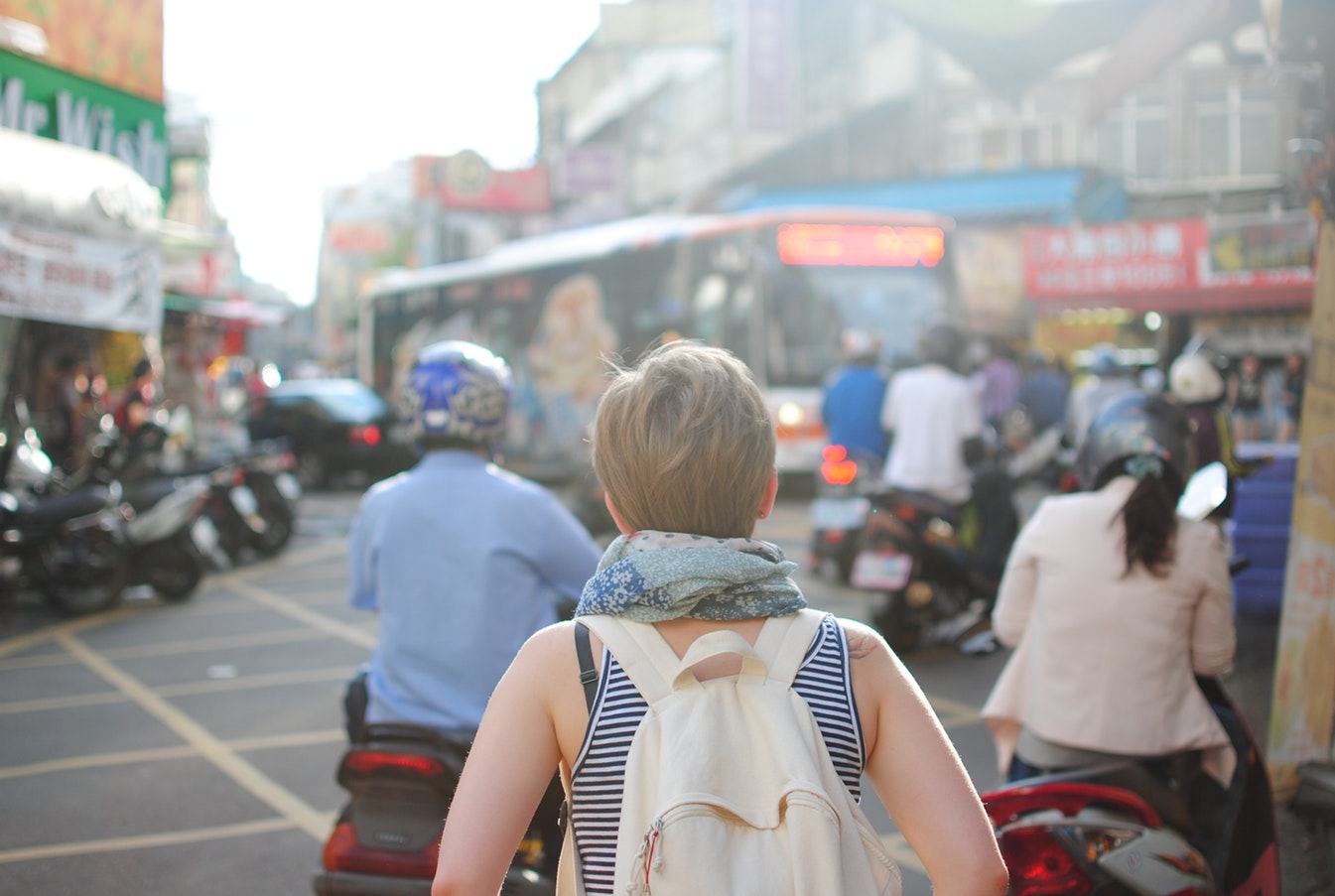 lady wearing a backpack on a street