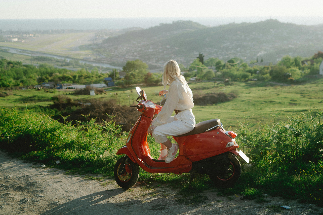 Person riding scooter in the outdoors