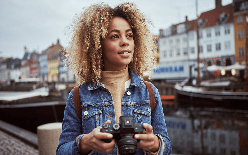 woman holding camera smiling